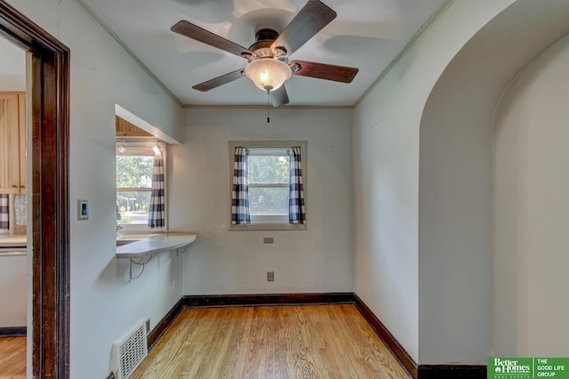 902 S 57th St, Omaha, NE 68106 - unfurnished room with light wood finished floors, ceiling fan, and crown molding