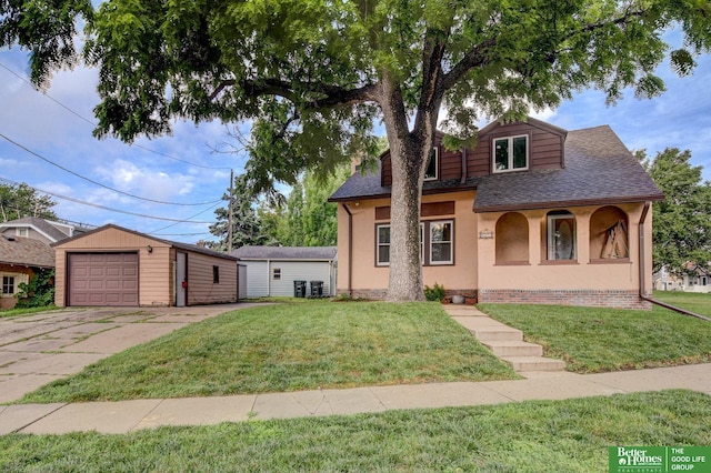 902 S 57th St, Omaha, NE 68106 - view of front facade with an outdoor structure, a garage, roof with shingles, stucco siding, and a front lawn