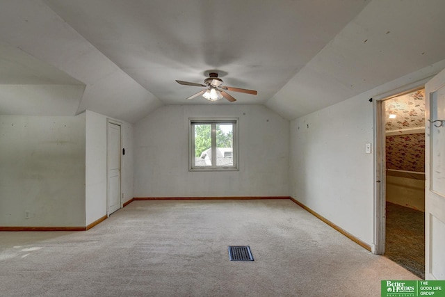 902 S 57th St, Omaha, NE 68106 - additional living space featuring light carpet, vaulted ceiling, and a ceiling fan
