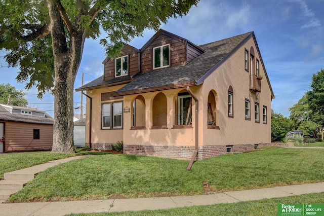902 S 57th St, Omaha, NE 68106 - view of front of house featuring a front lawn, stucco siding, and roof with shingles