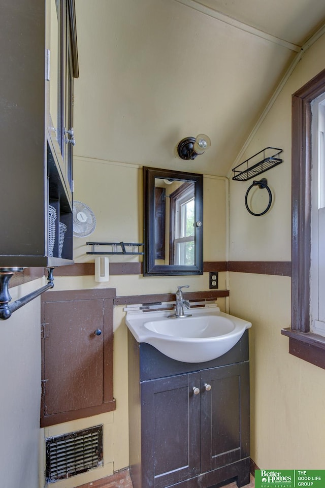902 S 57th St, Omaha, NE 68106 - bathroom featuring lofted ceiling and vanity