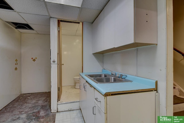 902 S 57th St, Omaha, NE 68106 - kitchen with a paneled ceiling, white cabinetry, and light countertops