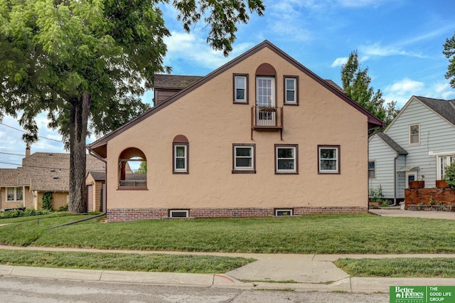 902 S 57th St, Omaha, NE 68106 - view of home's exterior with a yard and stucco siding