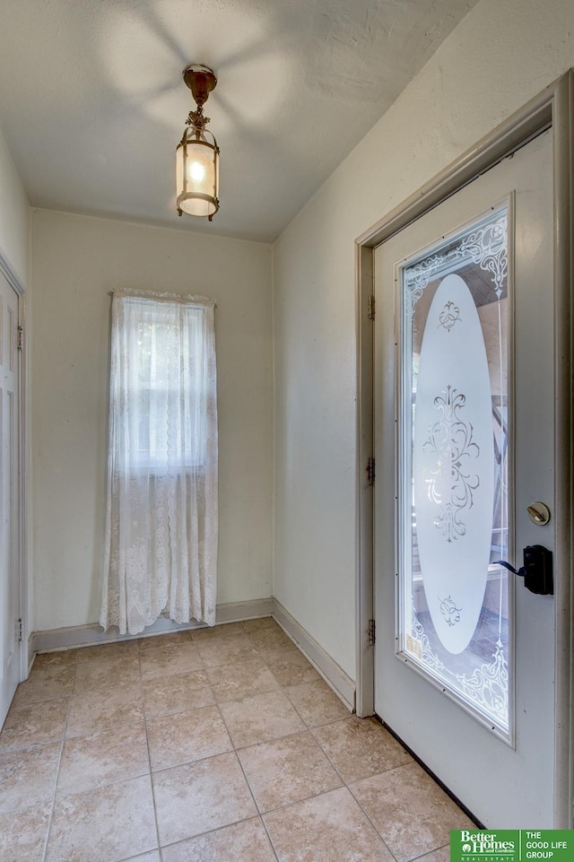902 S 57th St, Omaha, NE 68106 - foyer entrance featuring baseboards and light tile patterned floors