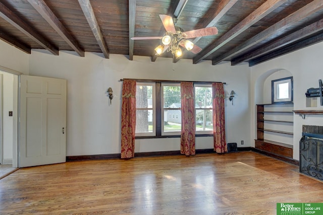 902 S 57th St, Omaha, NE 68106 - unfurnished living room featuring a wood ceiling with exposed beams, wood finished floors, a fireplace, and a ceiling fan