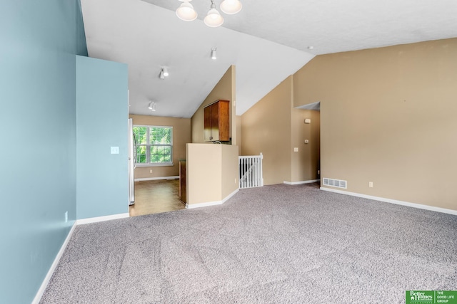 14463 Reynolds St, Omaha, NE 68007 - unfurnished living room featuring carpet flooring and lofted ceiling
