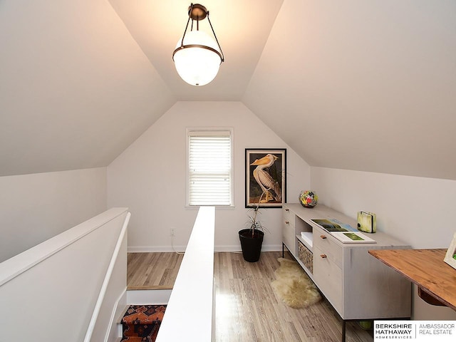 6144 Seward St, Omaha, NE 68104 - additional living space featuring light wood finished floors, vaulted ceiling, an office area, and baseboards