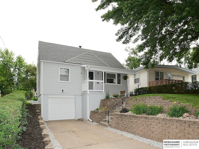 6144 Seward St, Omaha, NE 68104 - view of front of property featuring driveway, roof with shingles, and an attached garage