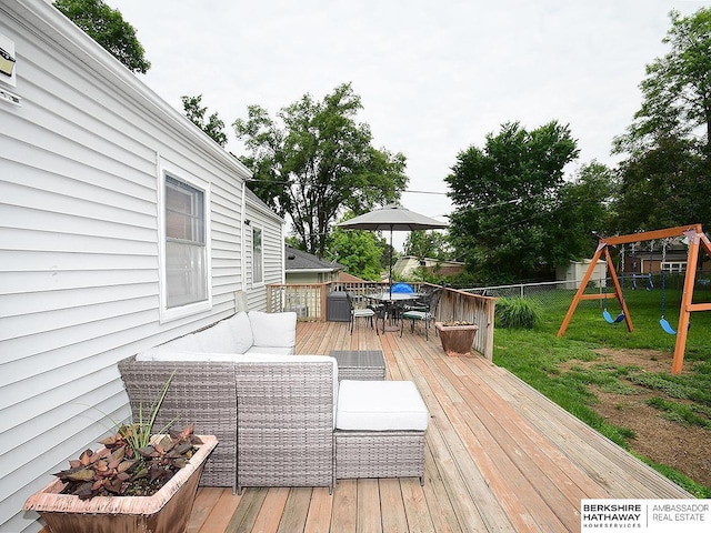 6144 Seward St, Omaha, NE 68104 - wooden terrace featuring outdoor dining space, an outdoor living space, and a playground