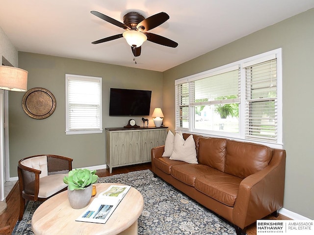 6144 Seward St, Omaha, NE 68104 - living room featuring dark wood-type flooring, baseboards, and ceiling fan