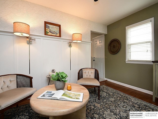 6144 Seward St, Omaha, NE 68104 - sitting room with wood finished floors, a decorative wall, wainscoting, baseboards, and wallpapered walls