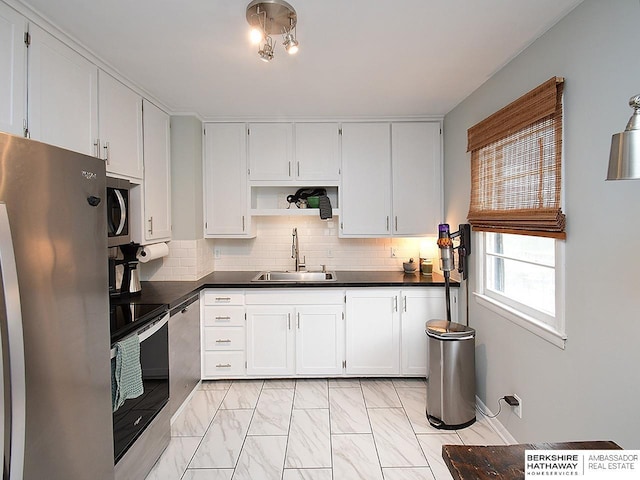 6144 Seward St, Omaha, NE 68104 - kitchen featuring appliances with stainless steel finishes, a sink, dark countertops, open shelves, and tasteful backsplash