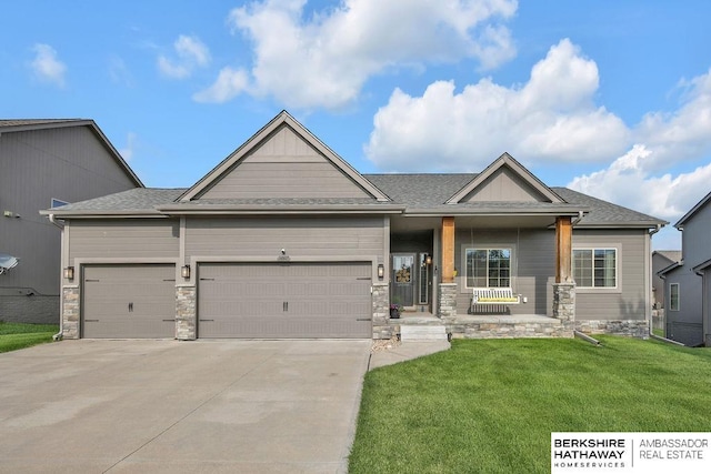 14807 S 24th St, Bellevue, NE 68123 - craftsman-style house with an attached garage, a front yard, driveway, covered porch, and stone siding