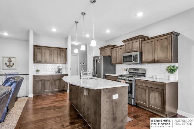 14807 S 24th St, Bellevue, NE 68123 - kitchen with appliances with stainless steel finishes, a sink, backsplash, a kitchen island with sink, and decorative light fixtures