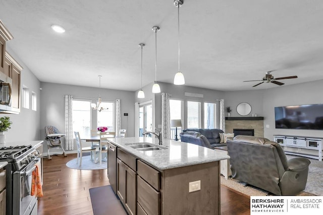 14807 S 24th St, Bellevue, NE 68123 - kitchen featuring a sink, appliances with stainless steel finishes, ceiling fan, a stone fireplace, and pendant lighting