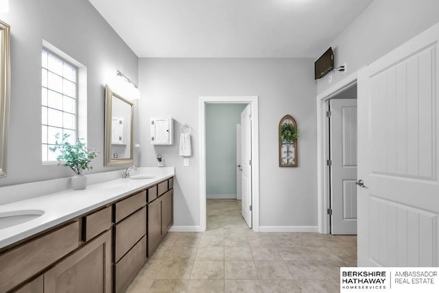 14807 S 24th St, Bellevue, NE 68123 - bathroom with double vanity, plenty of natural light, and baseboards
