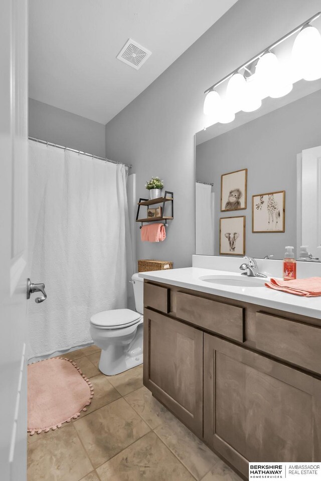 14807 S 24th St, Bellevue, NE 68123 - full bathroom featuring vanity, toilet, and tile patterned floors