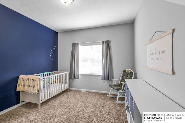 14807 S 24th St, Bellevue, NE 68123 - bedroom with carpet, baseboards, and a crib