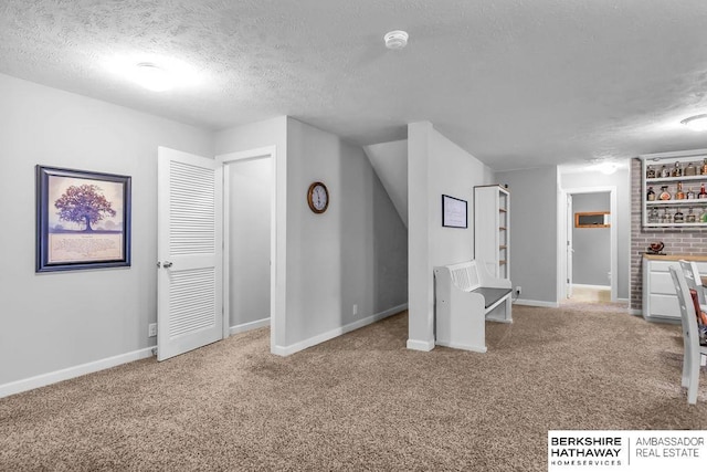 14807 S 24th St, Bellevue, NE 68123 - below grade area featuring a textured ceiling, carpet floors, and baseboards