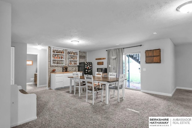 14807 S 24th St, Bellevue, NE 68123 - dining space featuring a textured ceiling, baseboards, and light carpet
