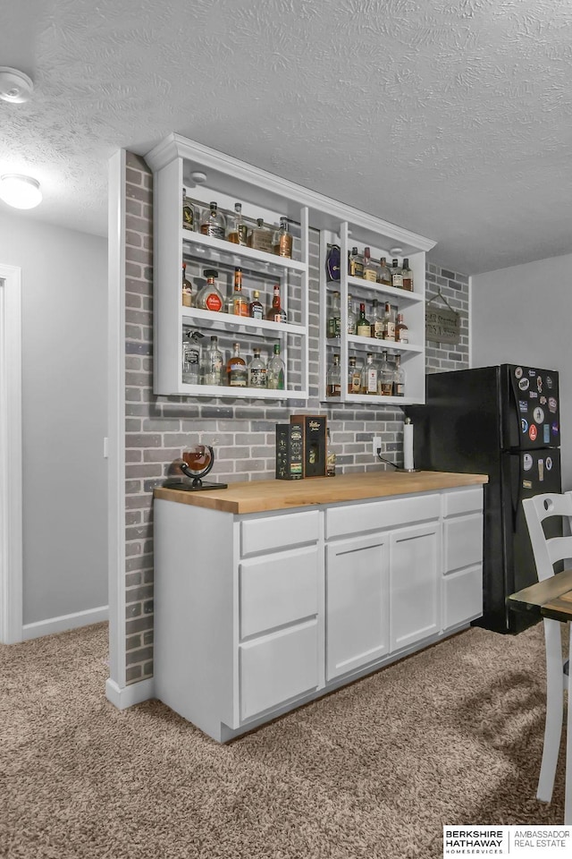 14807 S 24th St, Bellevue, NE 68123 - indoor bar with a textured ceiling, carpet, freestanding refrigerator, and baseboards