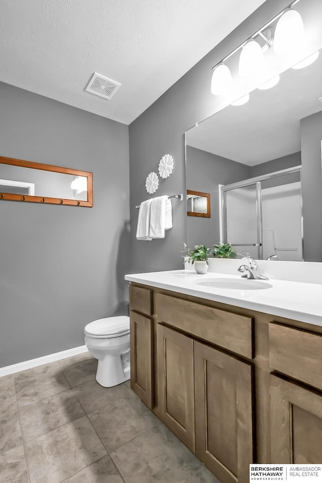 14807 S 24th St, Bellevue, NE 68123 - full bathroom with vanity, a shower stall, toilet, baseboards, and tile patterned flooring