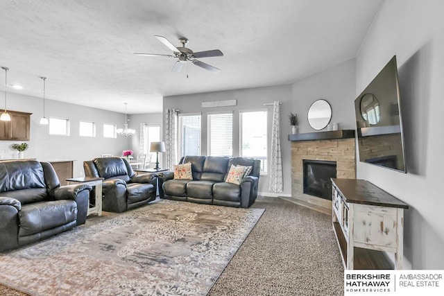 14807 S 24th St, Bellevue, NE 68123 - living room with ceiling fan, a stone fireplace, baseboards, and a chandelier