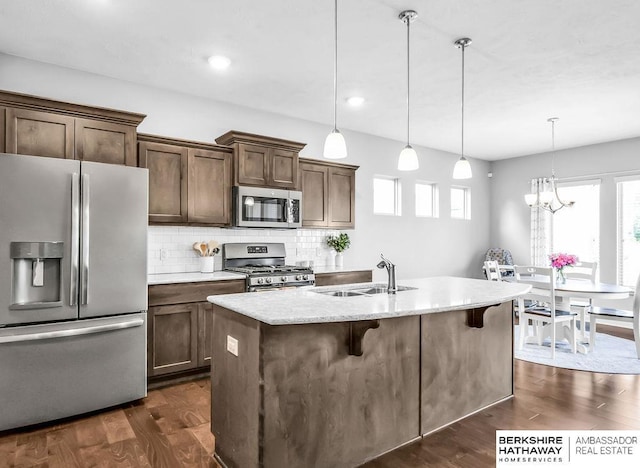 14807 S 24th St, Bellevue, NE 68123 - kitchen featuring appliances with stainless steel finishes, a sink, dark wood-style flooring, healthy amount of natural light, and recessed lighting