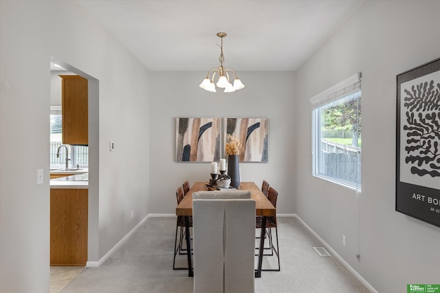 4602 N 155th Ave, Omaha, NE 68116 - dining room featuring a chandelier, baseboards, and light carpet