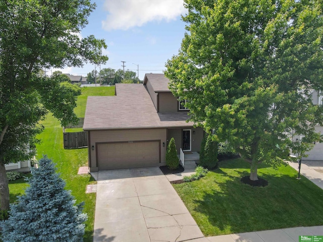 4602 N 155th Ave, Omaha, NE 68116 - view of property hidden behind natural elements featuring an attached garage, concrete driveway, and roof with shingles