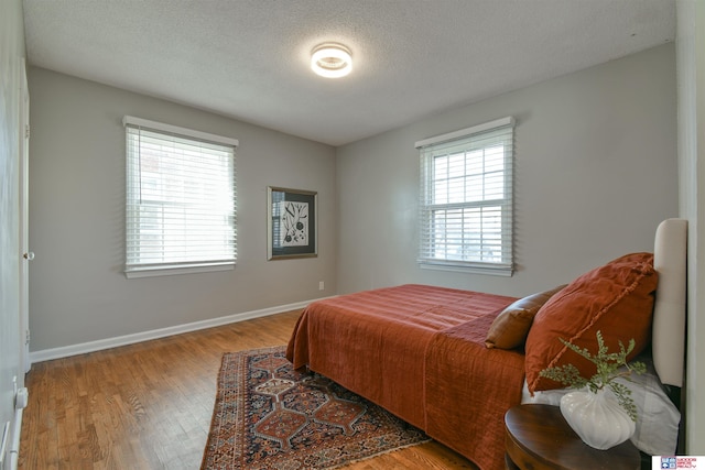 920 Clark Ave, Lincoln, NE 68510 - bedroom featuring wood finished floors, baseboards, and a textured ceiling