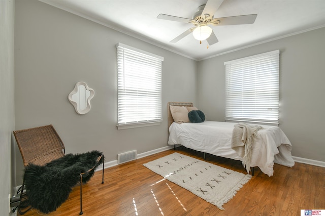 920 Clark Ave, Lincoln, NE 68510 - bedroom featuring baseboards, wood finished floors, crown molding, and a ceiling fan