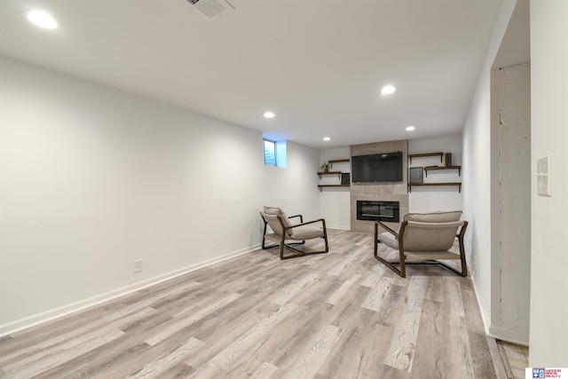 920 Clark Ave, Lincoln, NE 68510 - living area with recessed lighting, light wood finished floors, a tiled fireplace, and baseboards