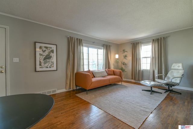 920 Clark Ave, Lincoln, NE 68510 - living area featuring plenty of natural light, a textured ceiling, wood finished floors, crown molding, and baseboards