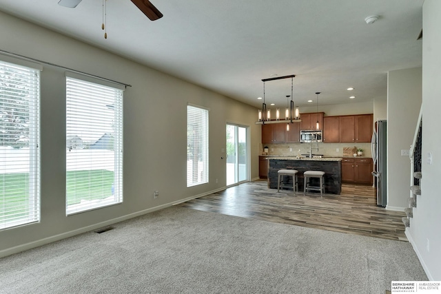 18337 Polk St, Omaha, NE 68135 - unfurnished living room featuring baseboards, ceiling fan, carpet, recessed lighting, and a sink