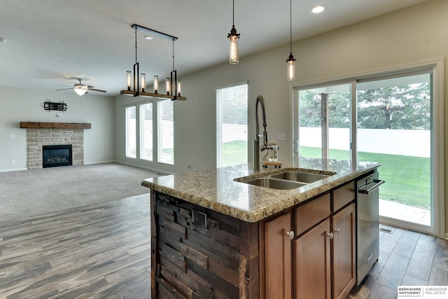 18337 Polk St, Omaha, NE 68135 - kitchen featuring a sink, light wood-type flooring, ceiling fan, a fireplace, and recessed lighting