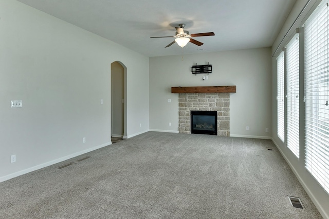 18337 Polk St, Omaha, NE 68135 - unfurnished living room with a ceiling fan, arched walkways, carpet, and a fireplace