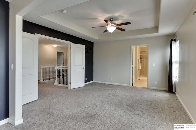 18337 Polk St, Omaha, NE 68135 - unfurnished bedroom with a raised ceiling, light colored carpet, baseboards, connected bathroom, and a ceiling fan