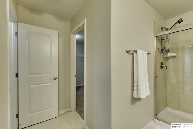 18337 Polk St, Omaha, NE 68135 - bathroom with a shower stall, tile patterned flooring, baseboards, and a walk in closet