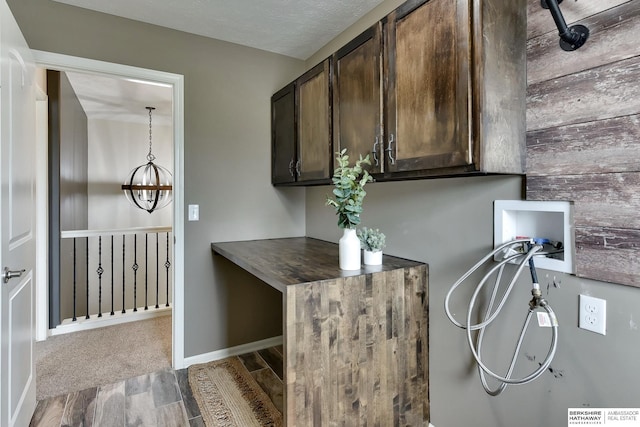 18337 Polk St, Omaha, NE 68135 - laundry area with cabinet space, washer hookup, wood finished floors, and baseboards