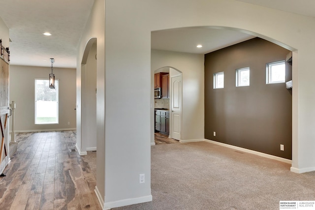18337 Polk St, Omaha, NE 68135 - foyer featuring recessed lighting, baseboards, arched walkways, and wood finished floors