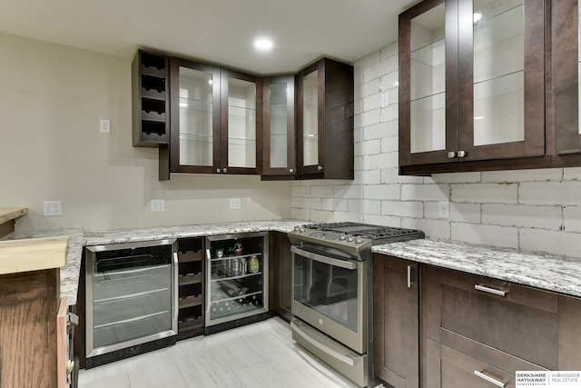 18337 Polk St, Omaha, NE 68135 - kitchen featuring gas range, dark brown cabinets, wine cooler, and light stone countertops