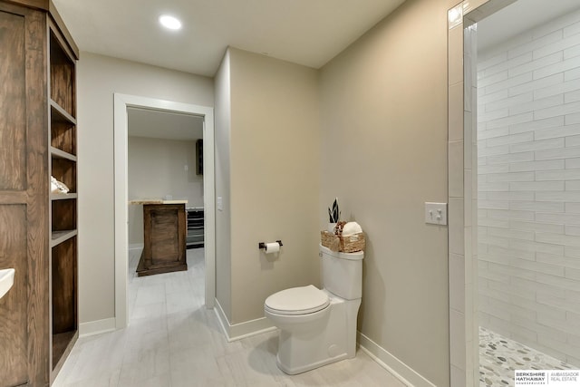 18337 Polk St, Omaha, NE 68135 - full bathroom with toilet, a tile shower, baseboards, and recessed lighting
