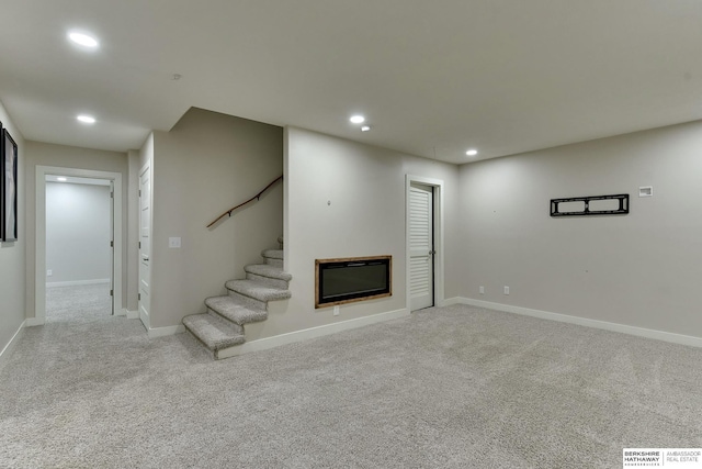 18337 Polk St, Omaha, NE 68135 - unfurnished living room with carpet flooring, recessed lighting, baseboards, and stairs