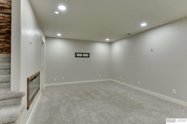 18337 Polk St, Omaha, NE 68135 - finished below grade area featuring recessed lighting, carpet flooring, heating unit, a glass covered fireplace, and baseboards