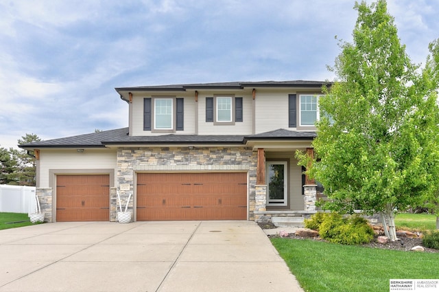 18337 Polk St, Omaha, NE 68135 - view of front of property with driveway, stone siding, and a garage