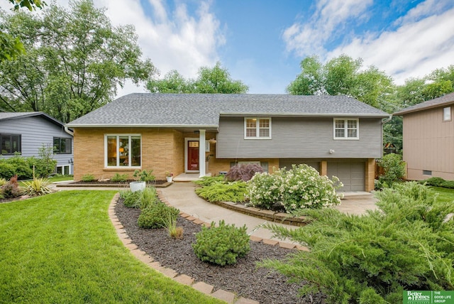 1008 J E George Blvd, Omaha, NE 68132 - split level home with an attached garage, a front lawn, brick siding, roof with shingles, and driveway