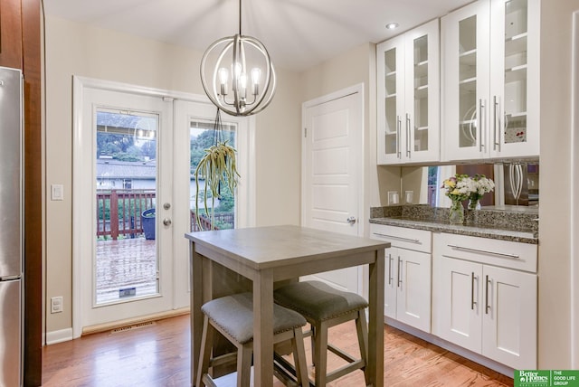 1008 J E George Blvd, Omaha, NE 68132 - dining room with a chandelier, light wood finished floors, and baseboards