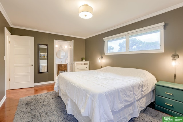 1008 J E George Blvd, Omaha, NE 68132 - bedroom featuring wood finished floors, ornamental molding, baseboards, and ensuite bath