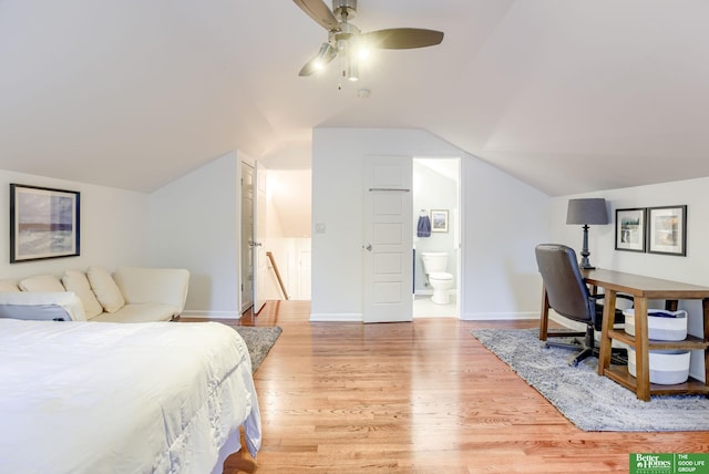 1008 J E George Blvd, Omaha, NE 68132 - bedroom featuring light wood-type flooring, lofted ceiling, baseboards, ensuite bath, and a ceiling fan